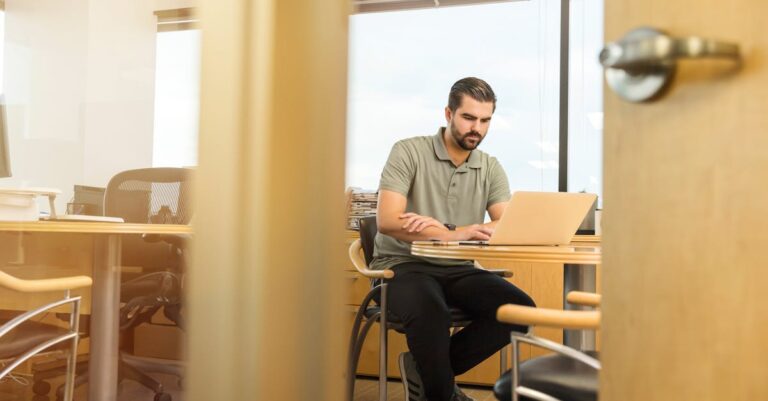Osoba pracująca na laptopie, przygotowująca się do założenia firmy online